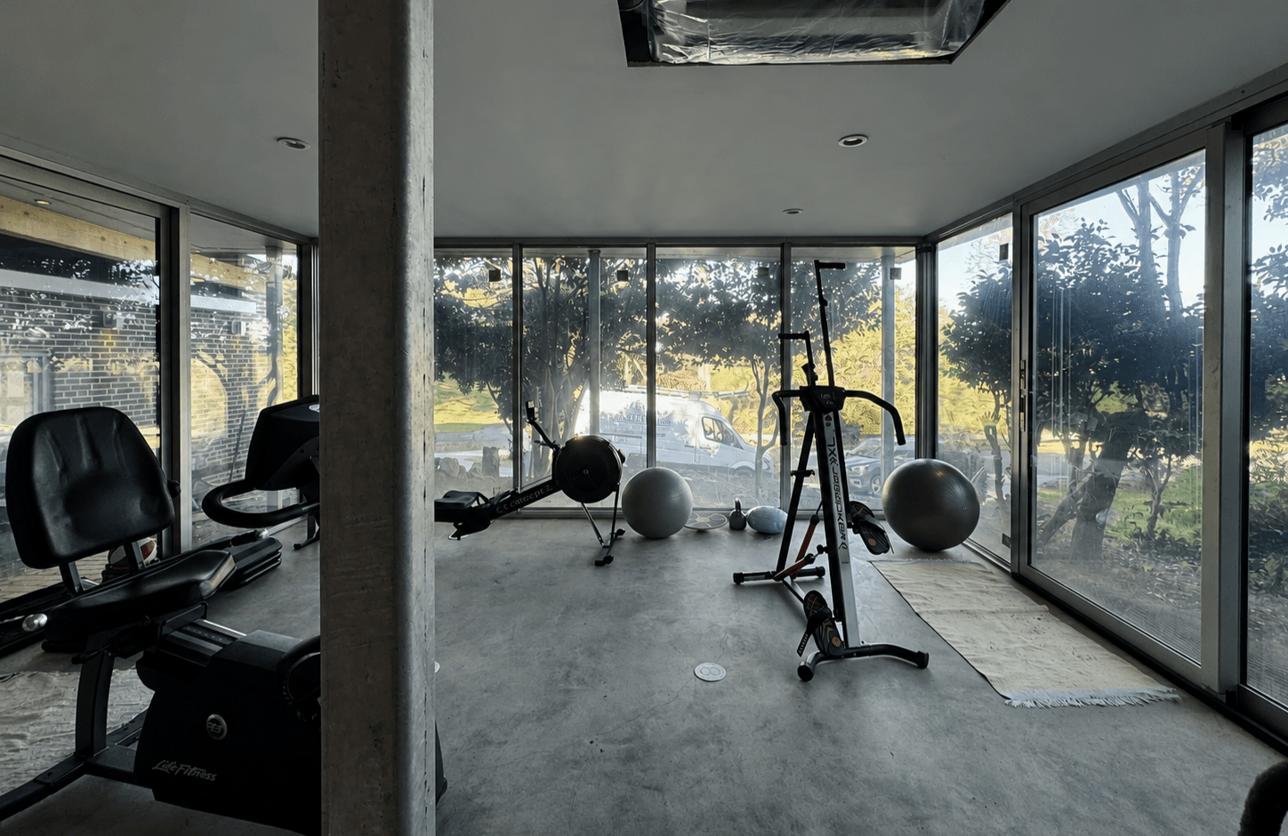 The studio interior, glazed on three sides, facing the garden.